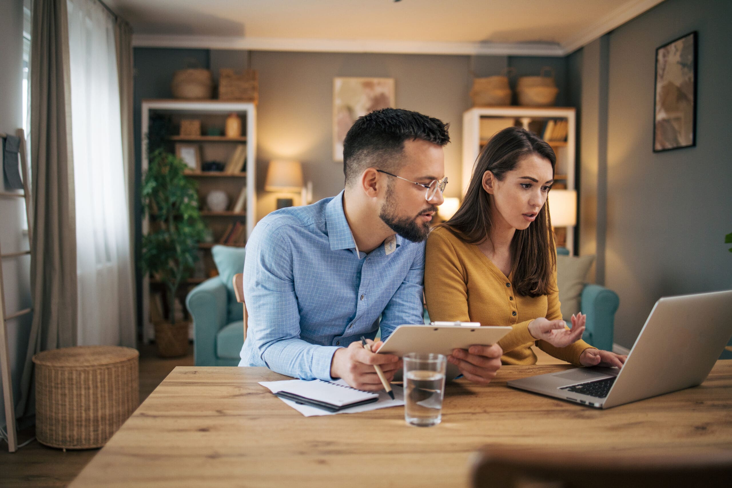 Busy couple working on finances in kitchen